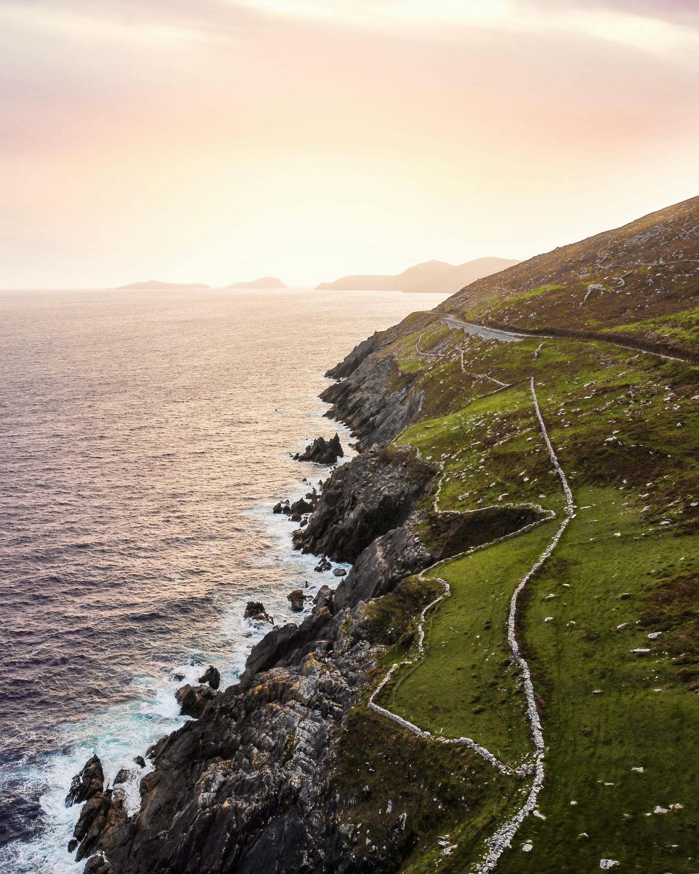 sanctuary-cottages-slea-head-drive1440x1800 Sun setting over the Blasket Isles, with the famous road of Slea Head Drive weaving along the rugged coastline.